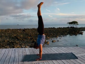 Building Joy WOMAN DOING HANDSTAND ON DOCK