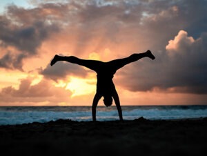 Impermanence. SUNSET HANDSTAND ON BEACH