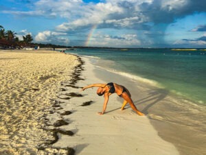 The Stories we Tell = Yoga on sunny beach atthe surf